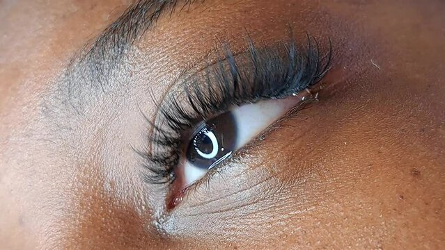 close up of eyelash extensions in beauty salon macro eye ,2d volume 3d volume,russian volume, classical style, remover,patches,lash technician,beautician,lashmaker,cat eye