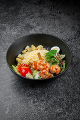 Salad with grated cheese, shrimp, avocado, pear, hard-boiled egg and croutons