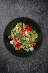 Caesar salad with croutons, cherry tomatoes, olives, cucumber and red onion