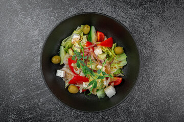 Caesar salad with croutons, cherry tomatoes, olives, cucumber and red onion