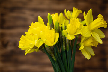 Obraz premium Yellow narcissus and daffodil on rustic wooden background, floral nature photography, Easter wallpaper