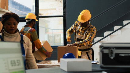 Depot workers team packing boxes with supplies, preparing stock for shipment order. Warehouse employees putting merchandise or goods in cardboard packages, products on racks and shelves. - Powered by Adobe