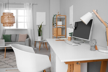 Stylish interior of light room with comfortable workplace