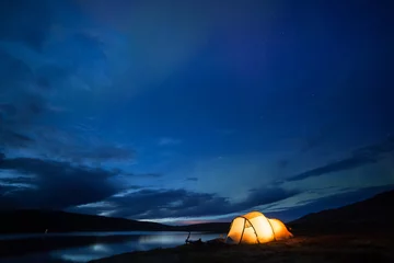 Foto auf Alu-Dibond Northern lights dancing over an iluminated tent in Norway © Alexander Erdbeer