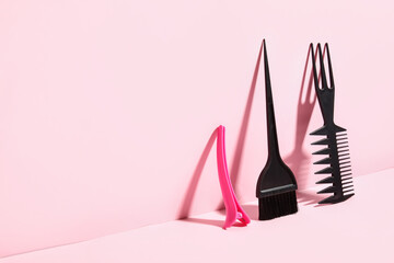 Set of hairdresser's tools on pink background