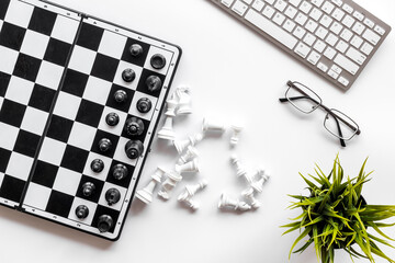 Competition in business concept. Chess board on office table, top view