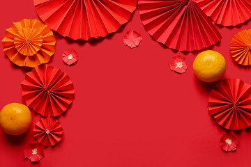 Fototapeta na wymiar Mandarins and oriental symbols on red background. New Year celebration