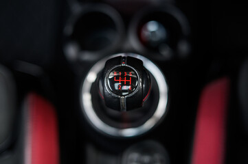 Close-up of Car Gear Stick Selector 6 Speed Manual with Red Detail