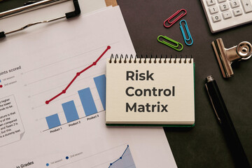 There is notebook with the word Risk Control Matrix. It is an abbreviation for Risk Control Matrix...
