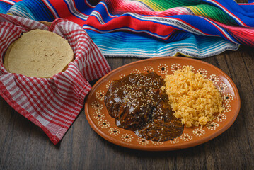 Mole, typical Mexican food. Traditional Mexican dish served in a clay dish.