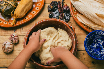 Person kneading nixtamalized corn dough to prepare tamales. Typical Mexican food.