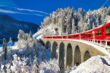 Rhaetian railway on viaduct in winter landscape, near Filisur, Canton Graubuenden, Switzerland, Europe