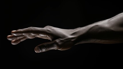 An image of a hand stretched out against a dark background.