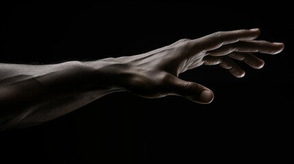 An image of a hand stretched out against a dark background.