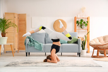 Young woman doing yoga  at home