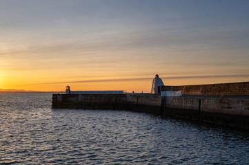 13 December 2023. Burghead, Moray, Scotland. This is a sunset glow on a December afternoon as the sun set viewed from Burghead Harbour.