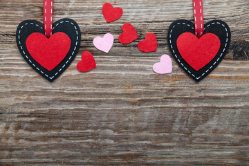 two hearts on a textured wooden background. Valentine's day background. Space for text.
