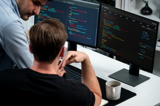 IT developers discussing online software development information on pc screen, creating program coding for latest version application on website. Concept of brainstorming firmware updated. Sellable.
