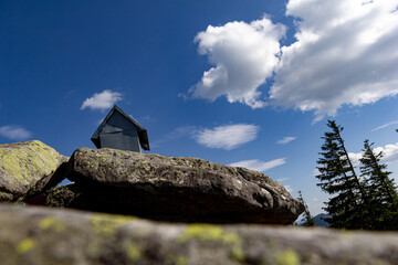 Close up view of rocks on top of mountain, blue sky with white clouds. Copy space