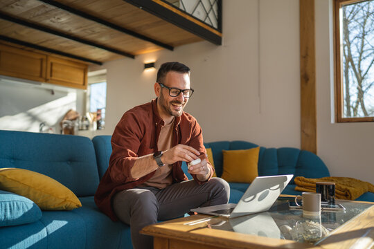 man sit at home use laptop computer to watch movie or have video call
