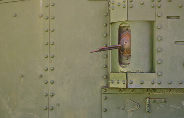 The texture of the wall of the tank, made of metal and reinforced with a multitude of bolts and rivets. Images of the covering of a combat vehicle from the Second World War with a guided machine gun