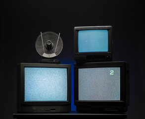 black vintage television sets on a dark background