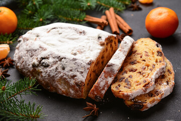 Tasty Christmas stollen on black background