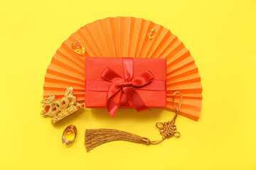 Gift box with Chinese symbols on yellow background. New Year celebration
