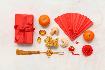Gift box with mandarins, fortune cookies and Chinese symbols on white grunge background. New Year...