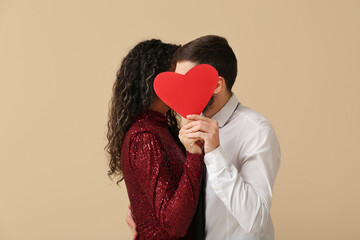 Couple with red heart for Valentine's day on beige background
