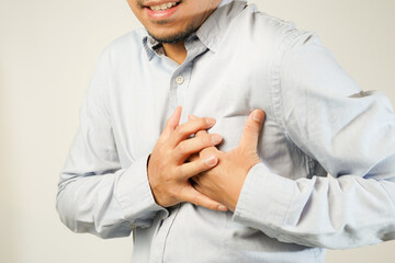 the man pressed his chest with a painful expression. Severe heartache, having a heart attack or...