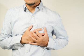 the man pressed his chest with a painful expression. Severe heartache, having a heart attack or...