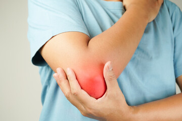 Health concept, person with elbow pain, man holding hand on elbow with pain, bone arthritis