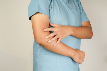 Health concept, person with elbow pain, man holding hand on elbow with pain, bone arthritis
