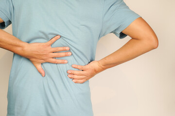 A man has chronic lower back pain and suffers from lower back pain