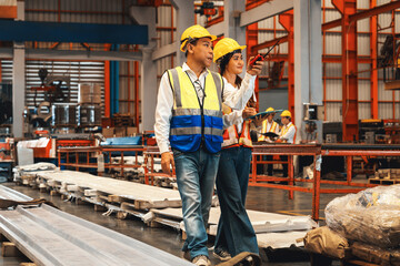 Factory foreman worker and engineer conduct inspection of steel machine and heavy industrial material quality product. Metal sheet manufacture with machinery safety and quality control. Exemplifying