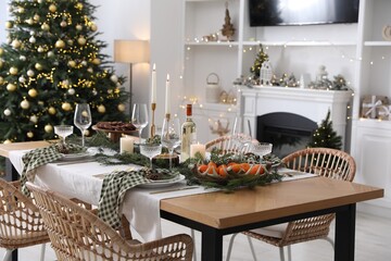 Christmas table setting with festive decor and dishware in living room