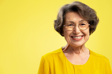 Portrait smiling attractive senior woman, cute happy grandmother wearing stylish eyeglasses looking...