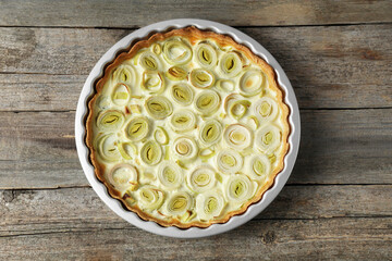 Tasty leek pie on old wooden table, top view