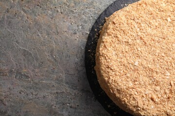 Delicious Napoleon cake on gray table, top view. Space for text