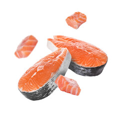 Fresh salmon steaks and pieces falling on white background