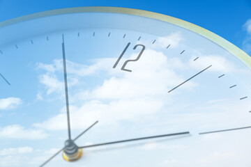 Time concept. Double exposure of blue sky with fluffy clouds and clock