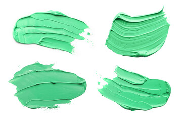 Light green oil paint strokes isolated on white, top view