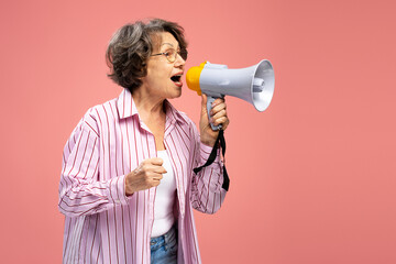 Portrait senior modern woman wearing  holding megaphone, talking announcing something isolated on...