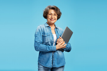 Beautiful attractive senior business woman, happy modern grandmother holding laptop computer...