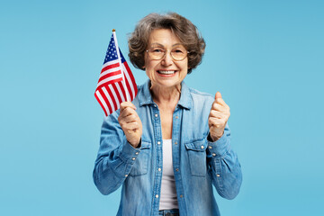 Portrait happy confident senior woman holding American flag celebration Independence Day isolated...
