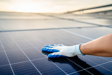 Engineer electrician using a hand to check solar panels on the roof, clean energy power nature,...