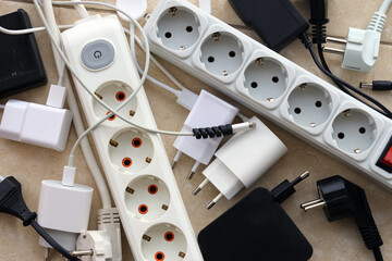 Many electrical plugs network congestion. The concept of electrical dependence. Lots of power plugs...