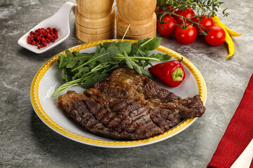 Grilled chuck roll steak with arugula
