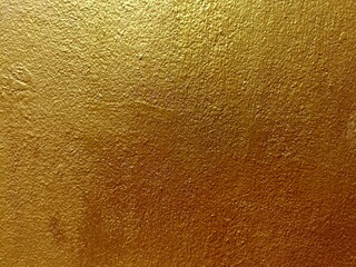 Gold color cement wall texture for background 